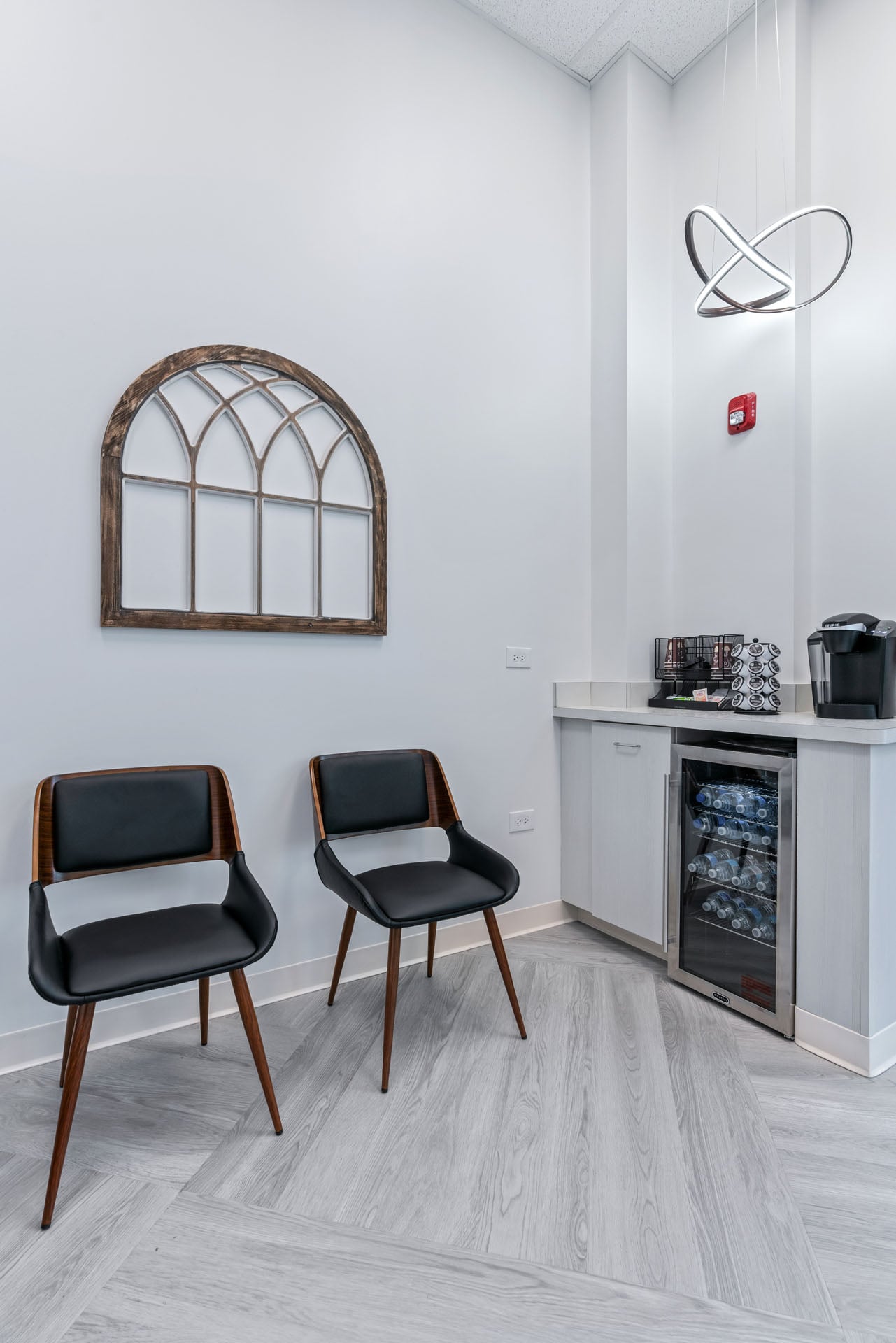 Waiting nook with seating and refreshments at Way Dental